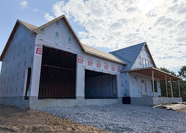 Single-family home featuring an attached two-car standard garage and an single tall-stall garage, showcasing a combination of functional and versatile vehicle storage, for your every day drivers and a camper, boat, or atvs.